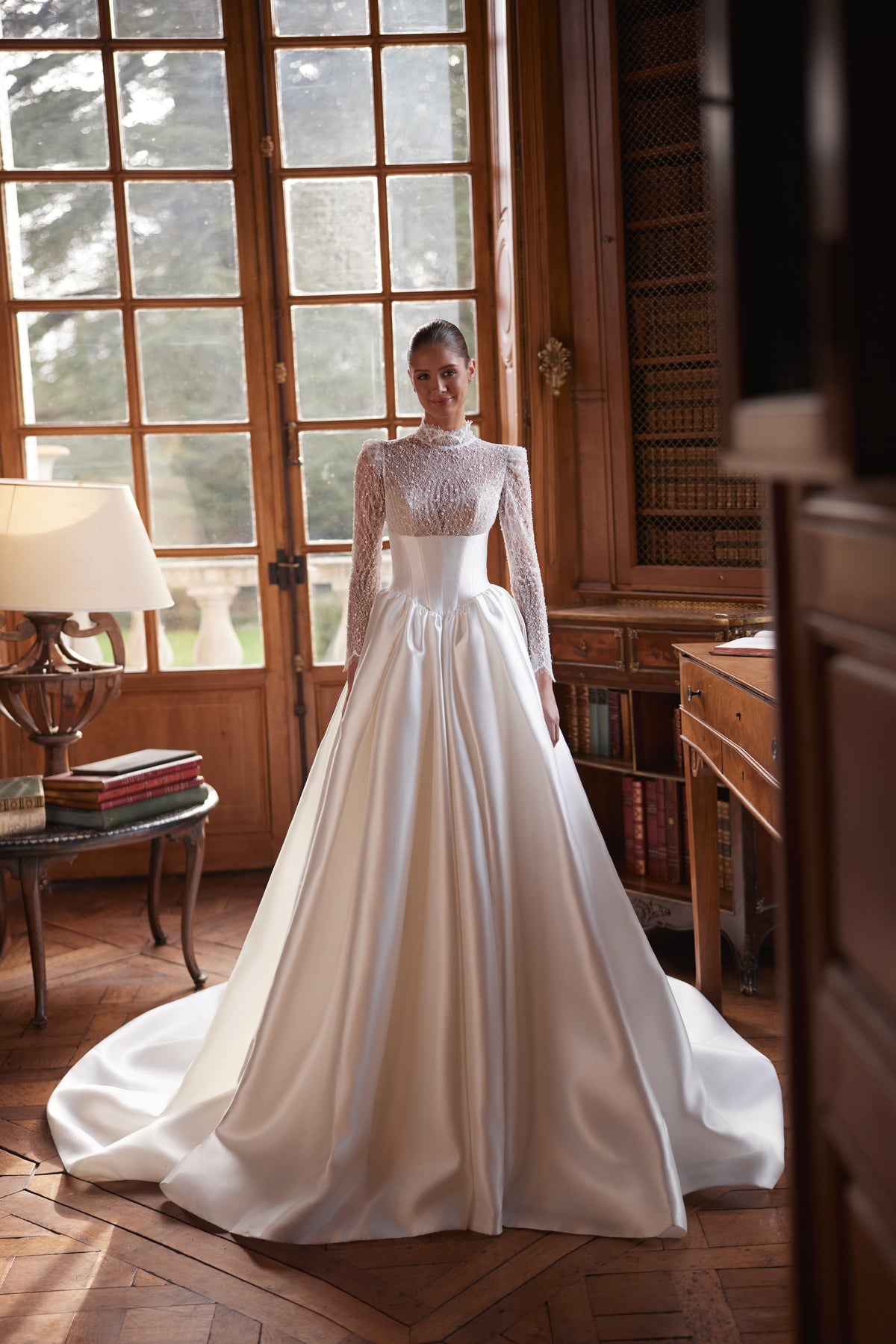 Abito da sposa Maristella – un corpetto in pizzo a collo alto con maniche lunghe e un’ampia gonna in raso.