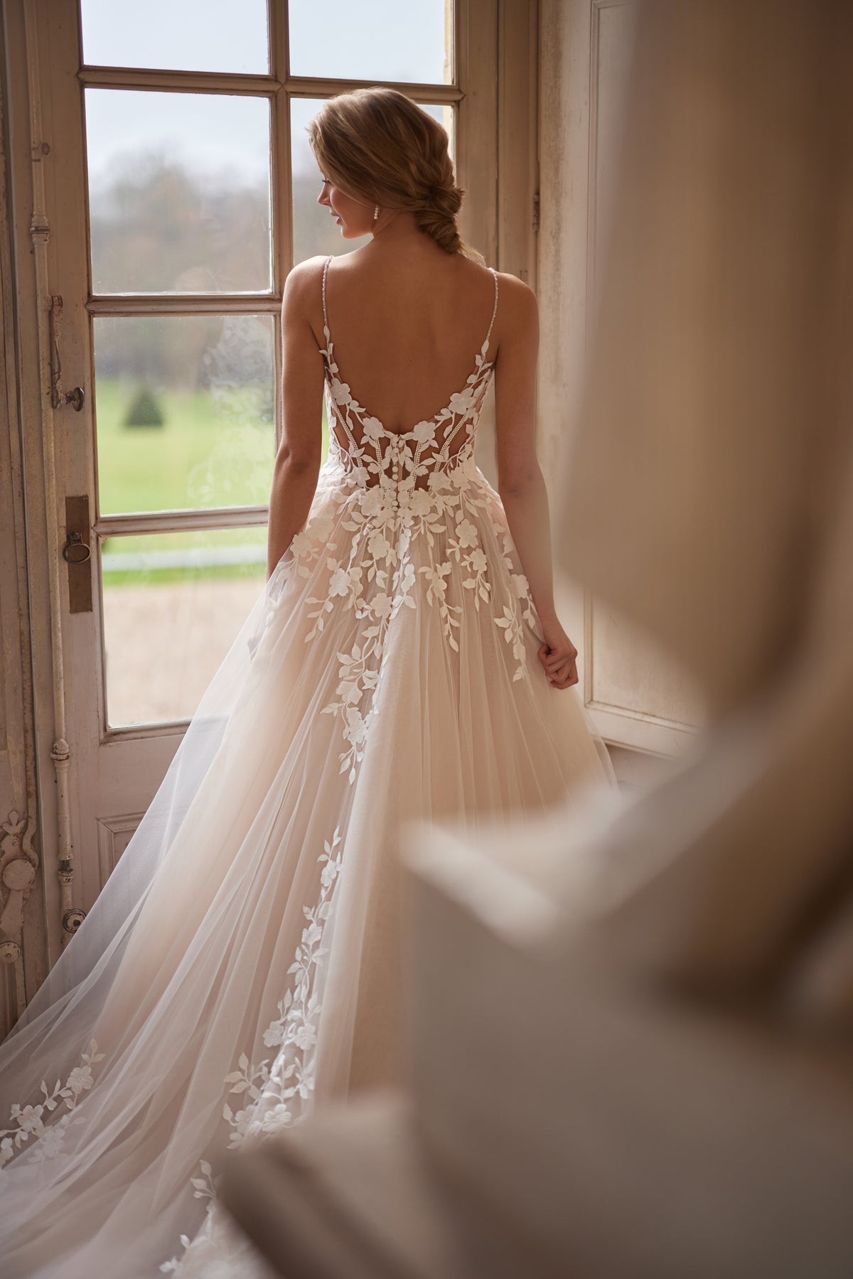 Abito da sposa Solene della collezione Something Blue 2027 – spalline delicate, uno scollo aperto e applicazioni in pizzo floreale.