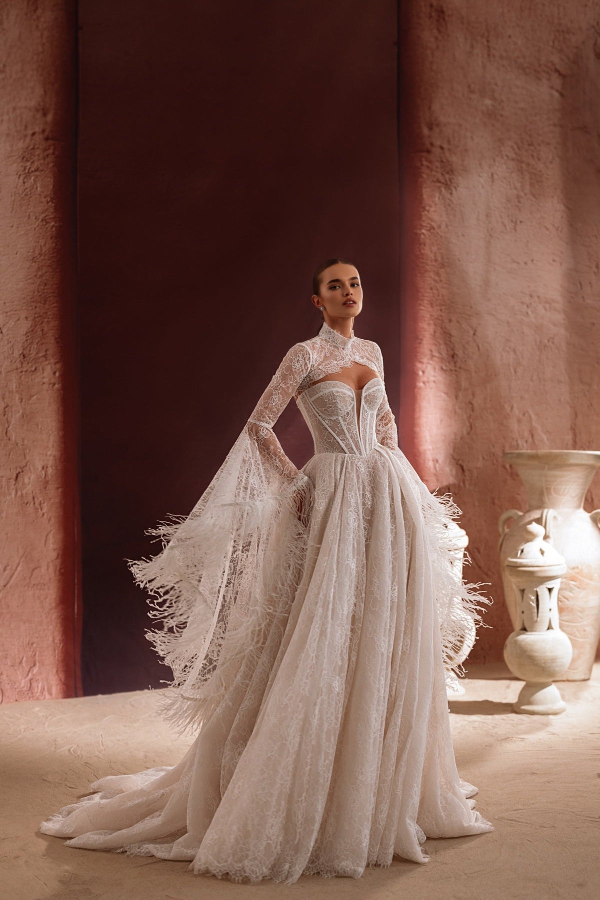 Il bolero da sposa Michelle in pizzo, con ricami elaborati, valorizza la figura elegante della sposa.